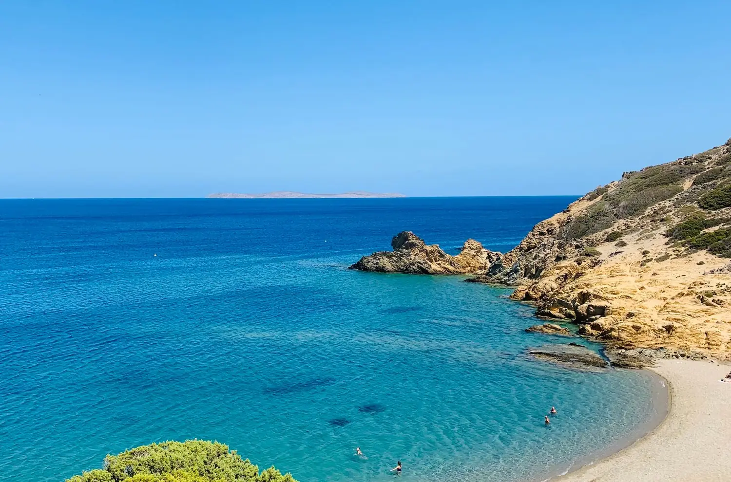 Secluded rocky beach with clear blue water along a Greek shore